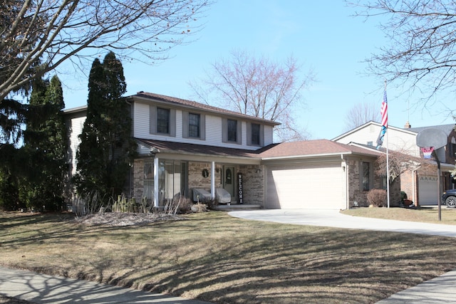 traditional-style house featuring brick siding, a front yard, covered porch, driveway, and an attached garage