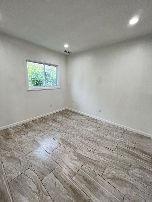 unfurnished room with recessed lighting, baseboards, and visible vents