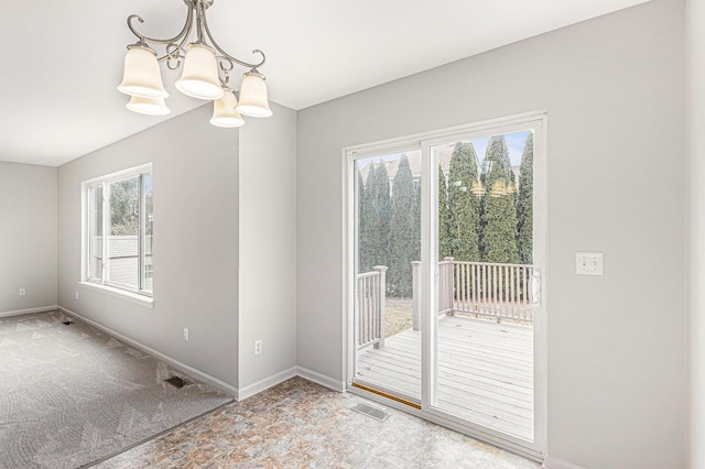 entryway featuring a notable chandelier, visible vents, baseboards, and carpet