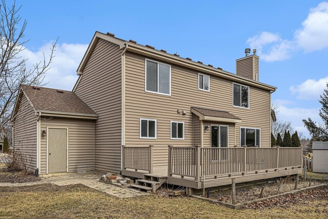 back of property featuring a deck and a chimney