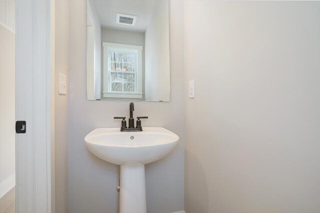 bathroom featuring visible vents and a sink