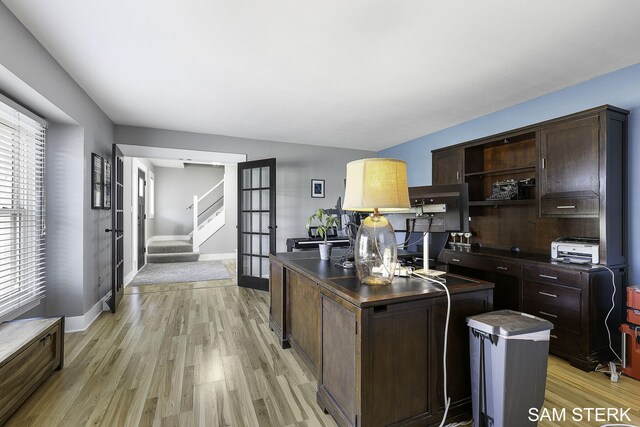 kitchen featuring light wood-style flooring, open shelves, a kitchen island, dark countertops, and dark brown cabinets