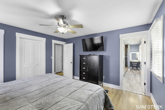 bedroom featuring a closet, ceiling fan, baseboards, and wood finished floors