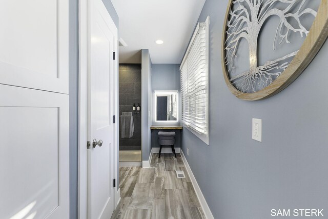 hallway featuring recessed lighting and baseboards