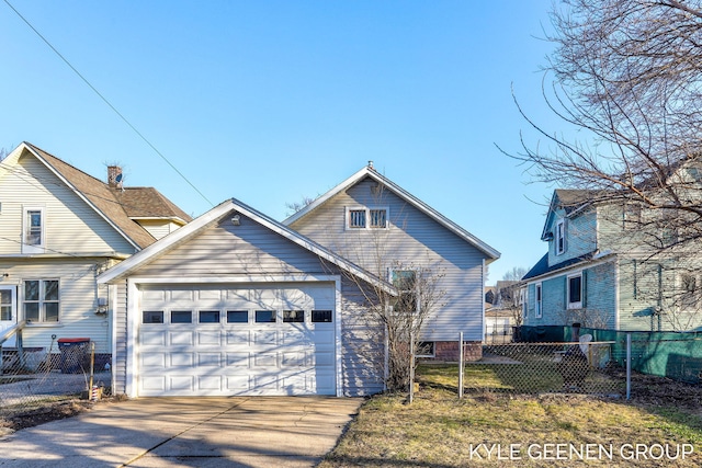 view of front of home featuring concrete driveway, an attached garage, and fence