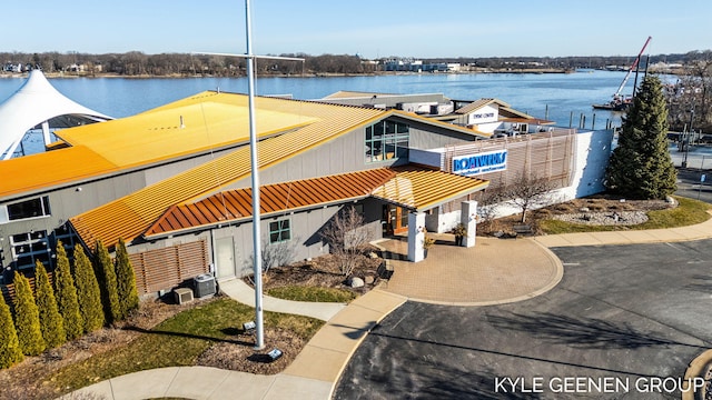 exterior space with a water view and fence