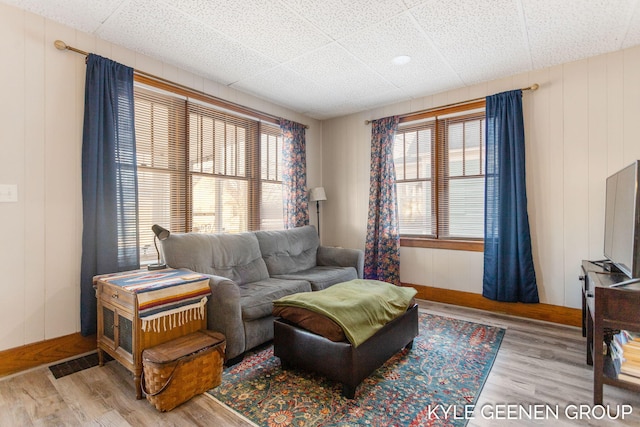 living area with visible vents and wood finished floors