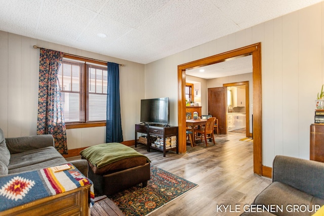 living area with light wood-style flooring and baseboards