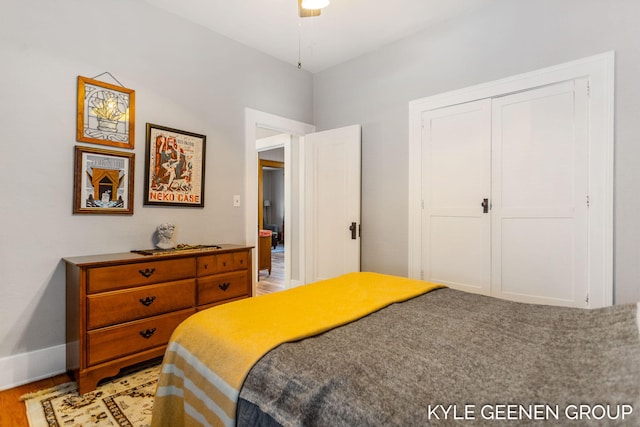 bedroom featuring a closet, light wood-style flooring, and baseboards