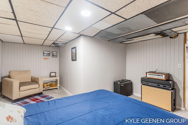 bedroom featuring baseboards and a drop ceiling