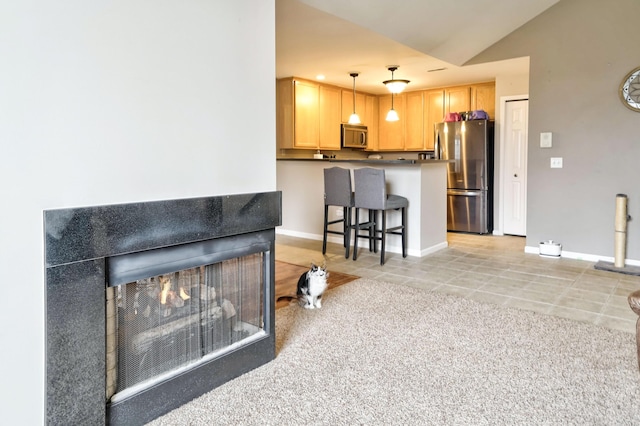 interior space featuring baseboards, a multi sided fireplace, light tile patterned flooring, and vaulted ceiling