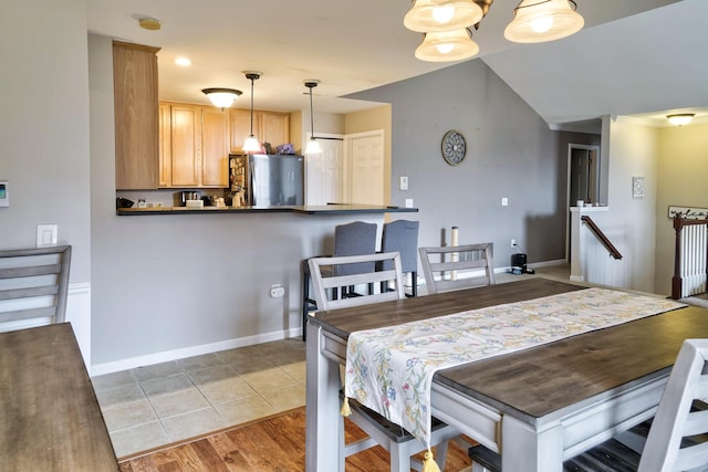 dining space with light tile patterned floors and baseboards