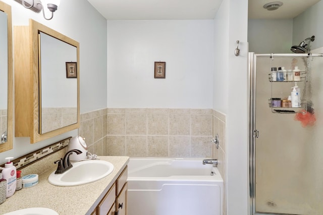 full bathroom with a sink, a garden tub, double vanity, and a shower stall