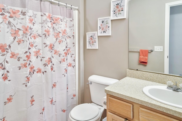 bathroom with toilet, vanity, and a shower with curtain