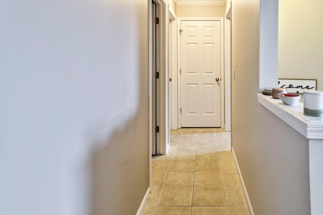 corridor with light tile patterned flooring and baseboards