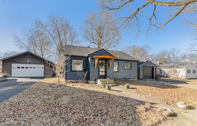 bungalow-style home featuring a shingled roof and a garage