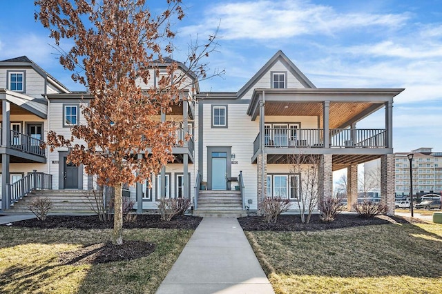 view of front facade featuring a balcony and a front yard