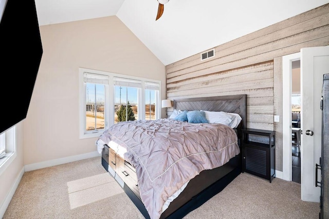 bedroom with visible vents, baseboards, carpet, wood walls, and a ceiling fan