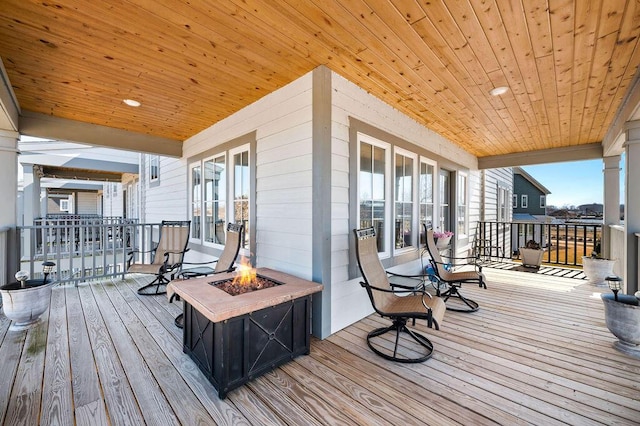 wooden terrace with a fire pit