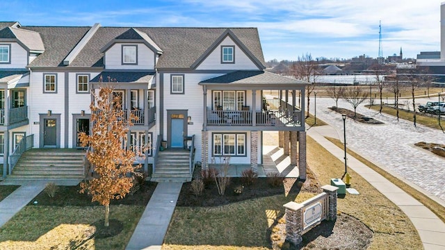 view of front of house featuring a balcony and roof with shingles