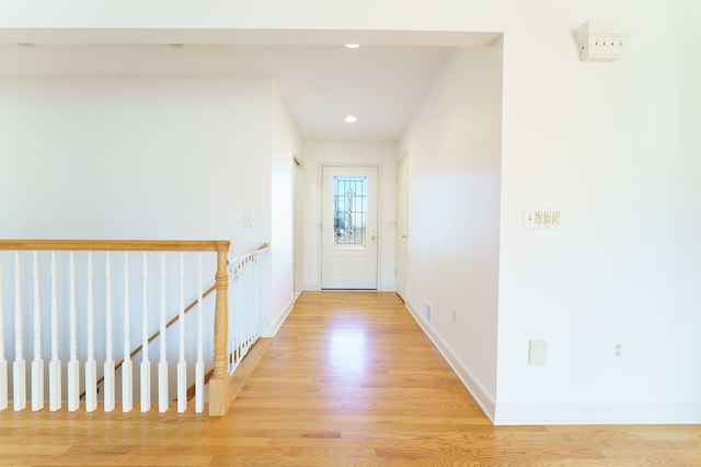 doorway to outside with recessed lighting, baseboards, and light wood-style floors