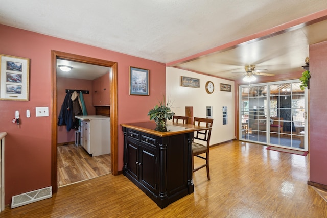 dining space featuring visible vents, ceiling fan, light wood-type flooring, and baseboards