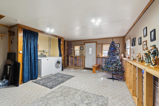 interior space featuring laundry area, crown molding, and washer and clothes dryer