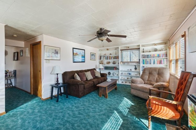 carpeted living area with ceiling fan