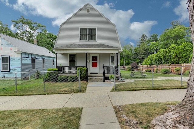 dutch colonial with a fenced front yard, a gambrel roof, covered porch, and a front yard