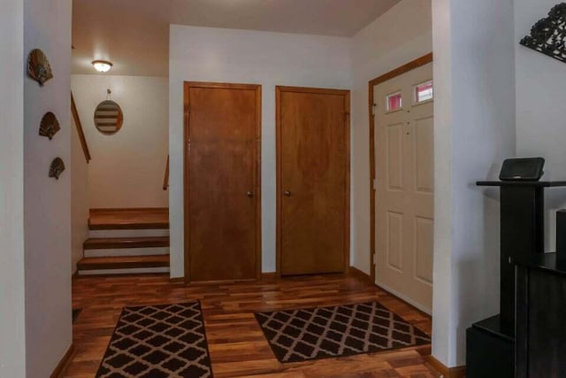 entryway featuring wood finished floors and stairs