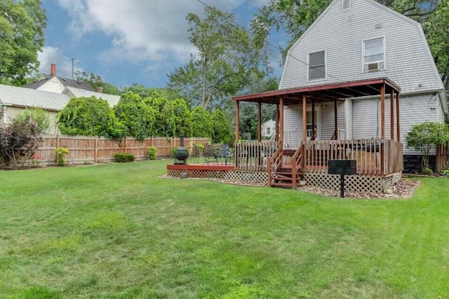 exterior space with a yard, a gambrel roof, and fence