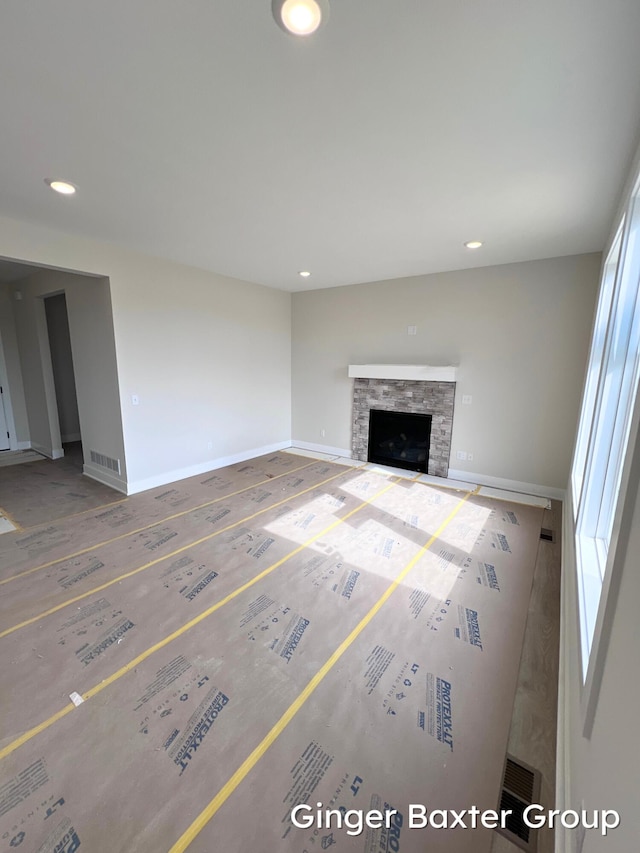 11328 Shoreline Dr Unit 118, Allendale, MI 49401 - unfurnished living room featuring recessed lighting, baseboards, wood finished floors, and a fireplace