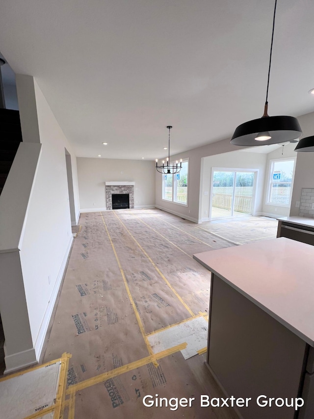 11328 Shoreline Dr Unit 118, Allendale, MI 49401 - unfurnished living room with baseboards, healthy amount of natural light, a fireplace, and recessed lighting