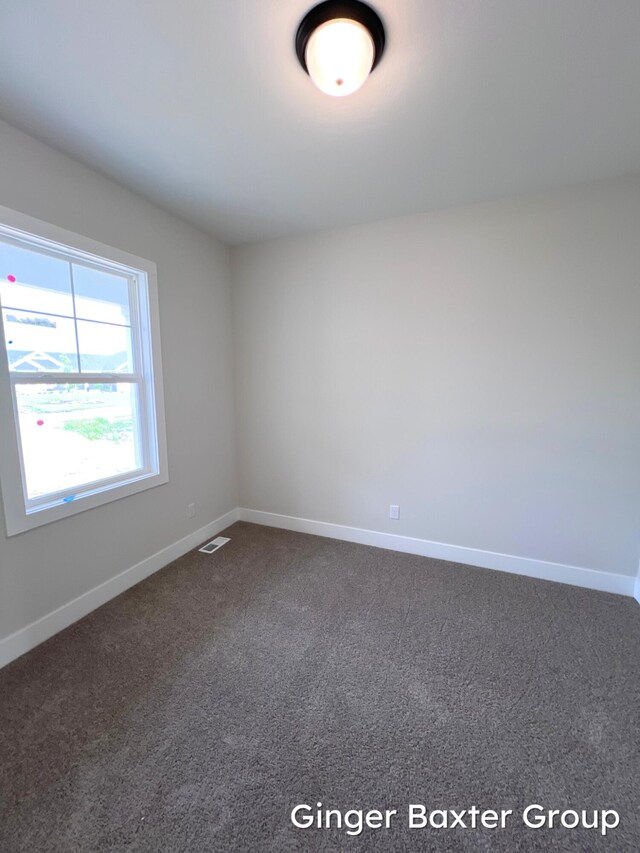 11328 Shoreline Dr Unit 118, Allendale, MI 49401 - unfurnished room with dark colored carpet and baseboards