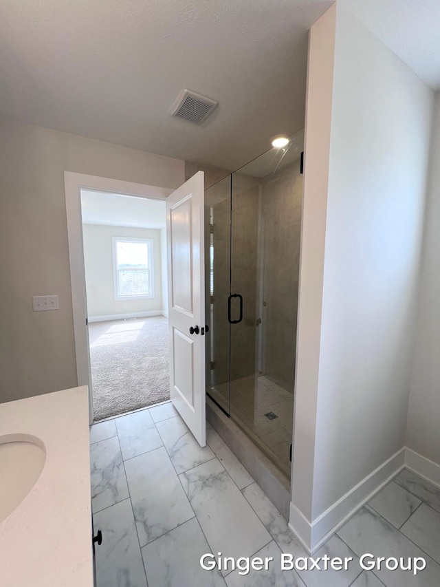 11328 Shoreline Dr Unit 118, Allendale, MI 49401 - bathroom featuring marble look tiles, baseboards, a shower stall, and vanity