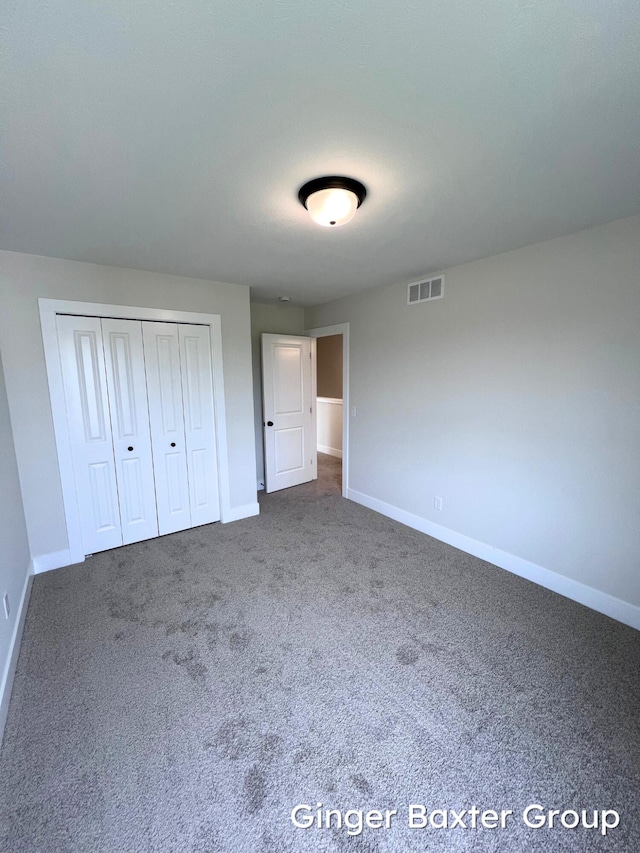 11328 Shoreline Dr Unit 118, Allendale, MI 49401 - unfurnished bedroom with baseboards, carpet, and a closet