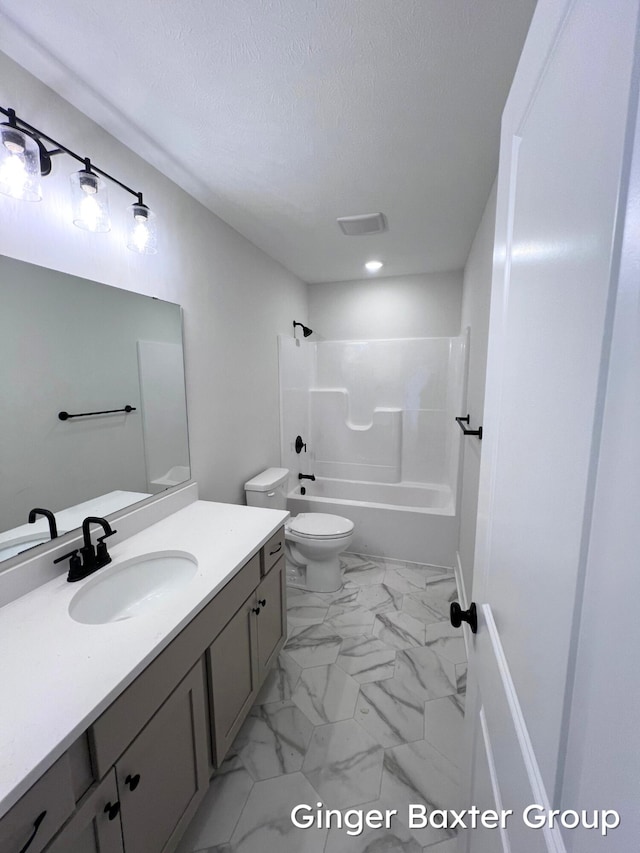 11328 Shoreline Dr Unit 118, Allendale, MI 49401 - bathroom with vanity, toilet, bathtub / shower combination, marble finish floors, and a textured ceiling
