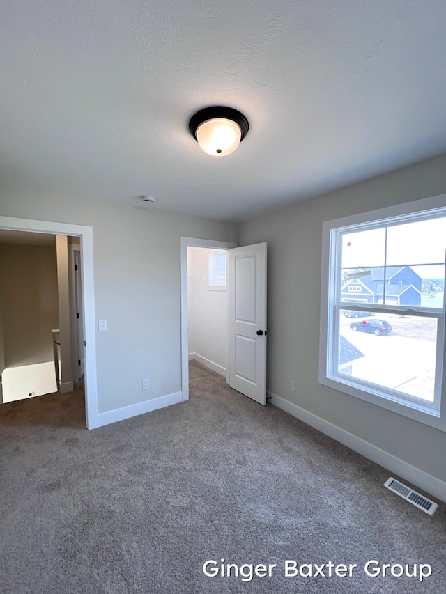11328 Shoreline Dr Unit 118, Allendale, MI 49401 - unfurnished bedroom featuring carpet and baseboards