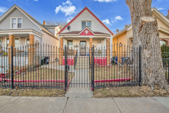 view of front of house featuring a gate, covered porch, and a fenced front yard