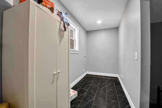 interior space featuring baseboards and marble finish floor