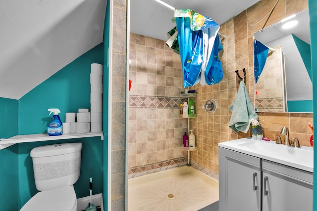 bathroom featuring tasteful backsplash, toilet, a stall shower, and vanity