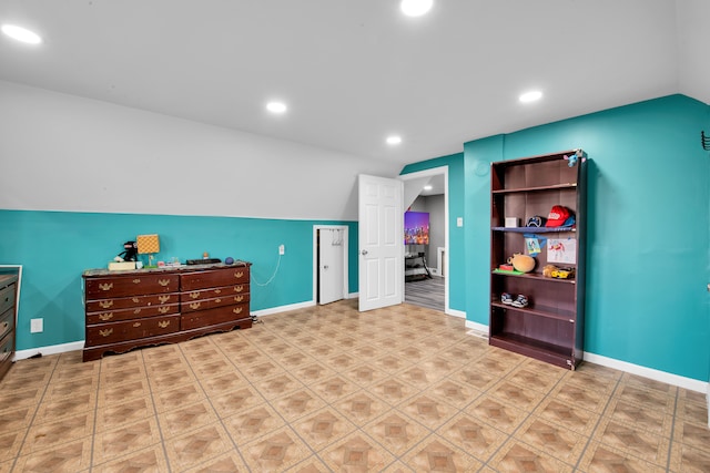 interior space featuring recessed lighting, baseboards, and lofted ceiling