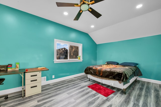 bedroom with recessed lighting, wood finished floors, baseboards, and vaulted ceiling