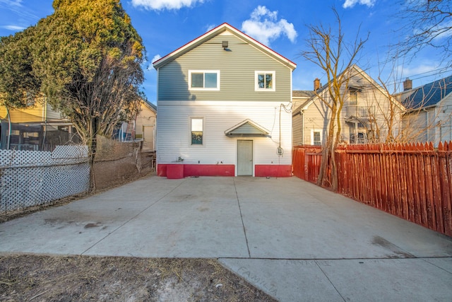 back of house featuring fence