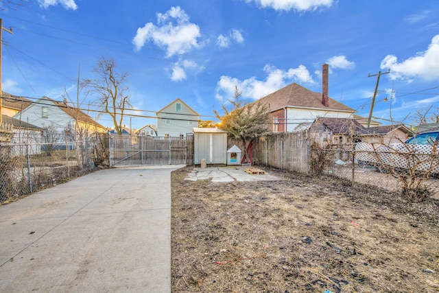 view of yard with a gate, an outbuilding, and fence