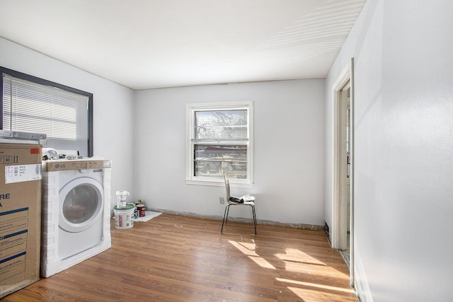 washroom featuring laundry area, washer / dryer, and wood finished floors