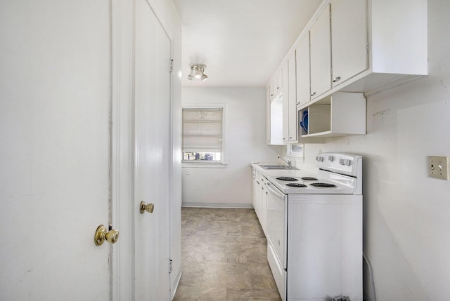 kitchen featuring a sink, baseboards, white cabinetry, and white electric stove