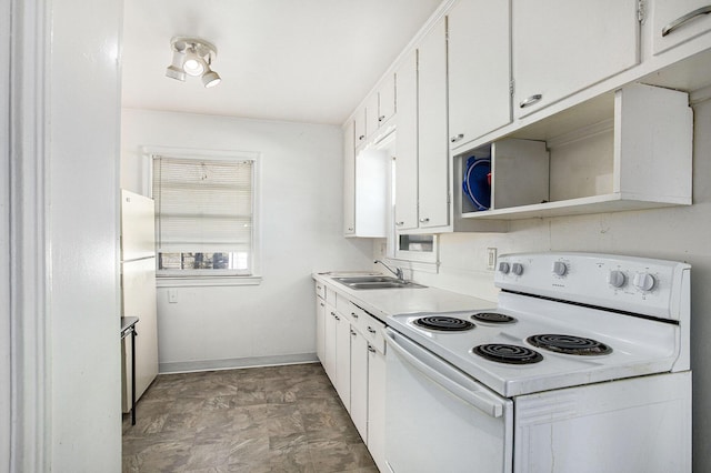 kitchen featuring white appliances, white cabinets, light countertops, and a sink