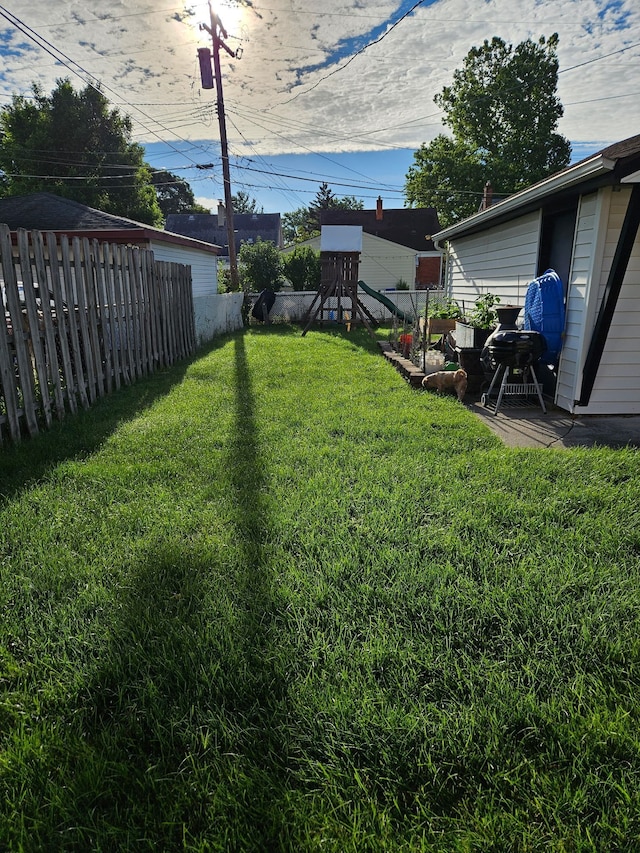 view of yard with a playground and fence