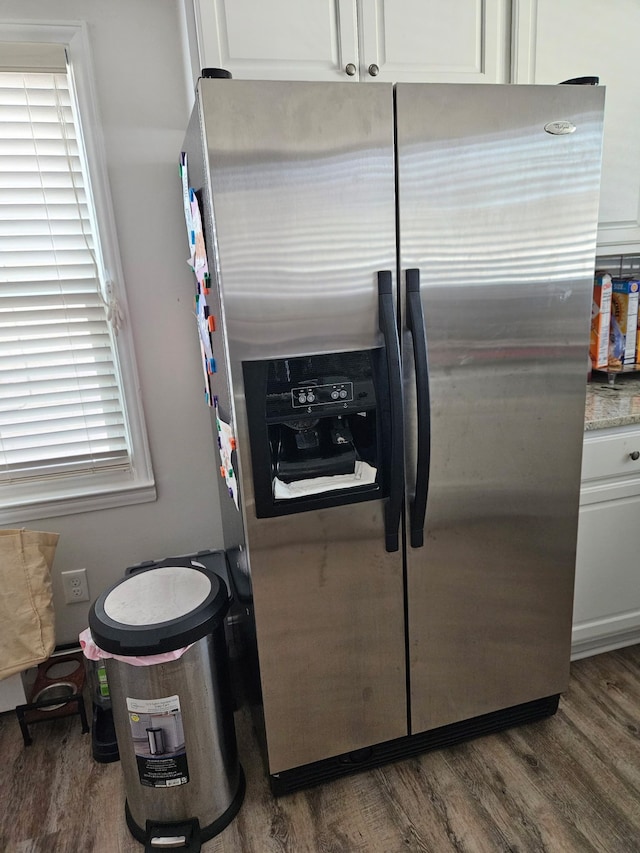 kitchen featuring white cabinets, wood finished floors, and stainless steel refrigerator with ice dispenser